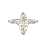 Diamond ring with a pear-shaped center stone on a white background