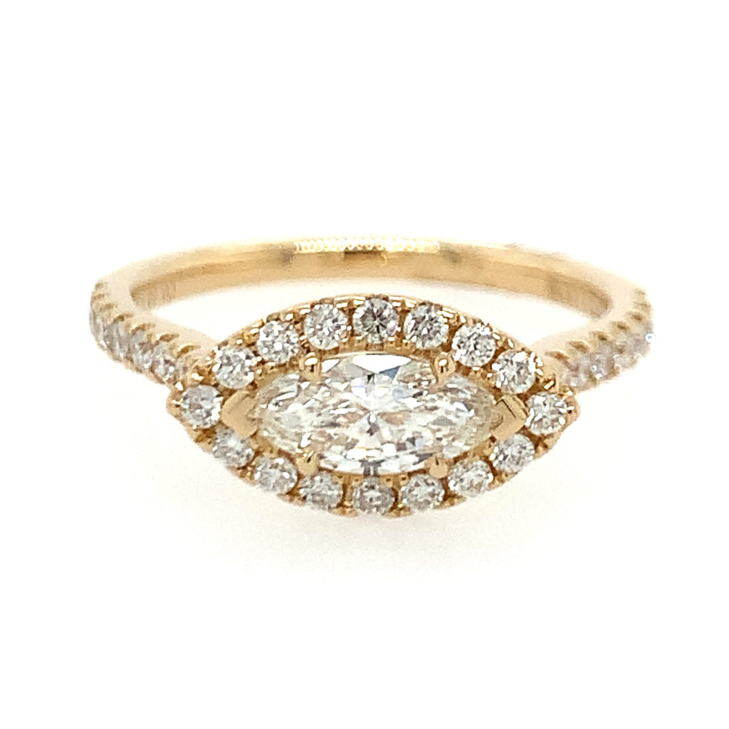 Gold ring with a central diamond and smaller diamonds on a white background