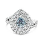Elegant ring with a pear-shaped blue gemstone and diamond halo on a white background