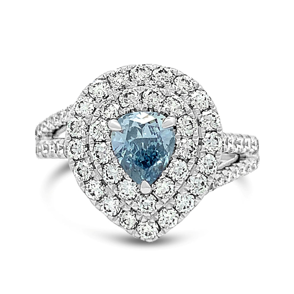 Ring with a blue gemstone and diamond halo on a white background