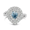 Ring with a blue gemstone and diamond halo on a white background
