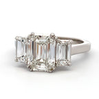 Diamond ring with emerald-cut center stone and baguette side stones on a white background