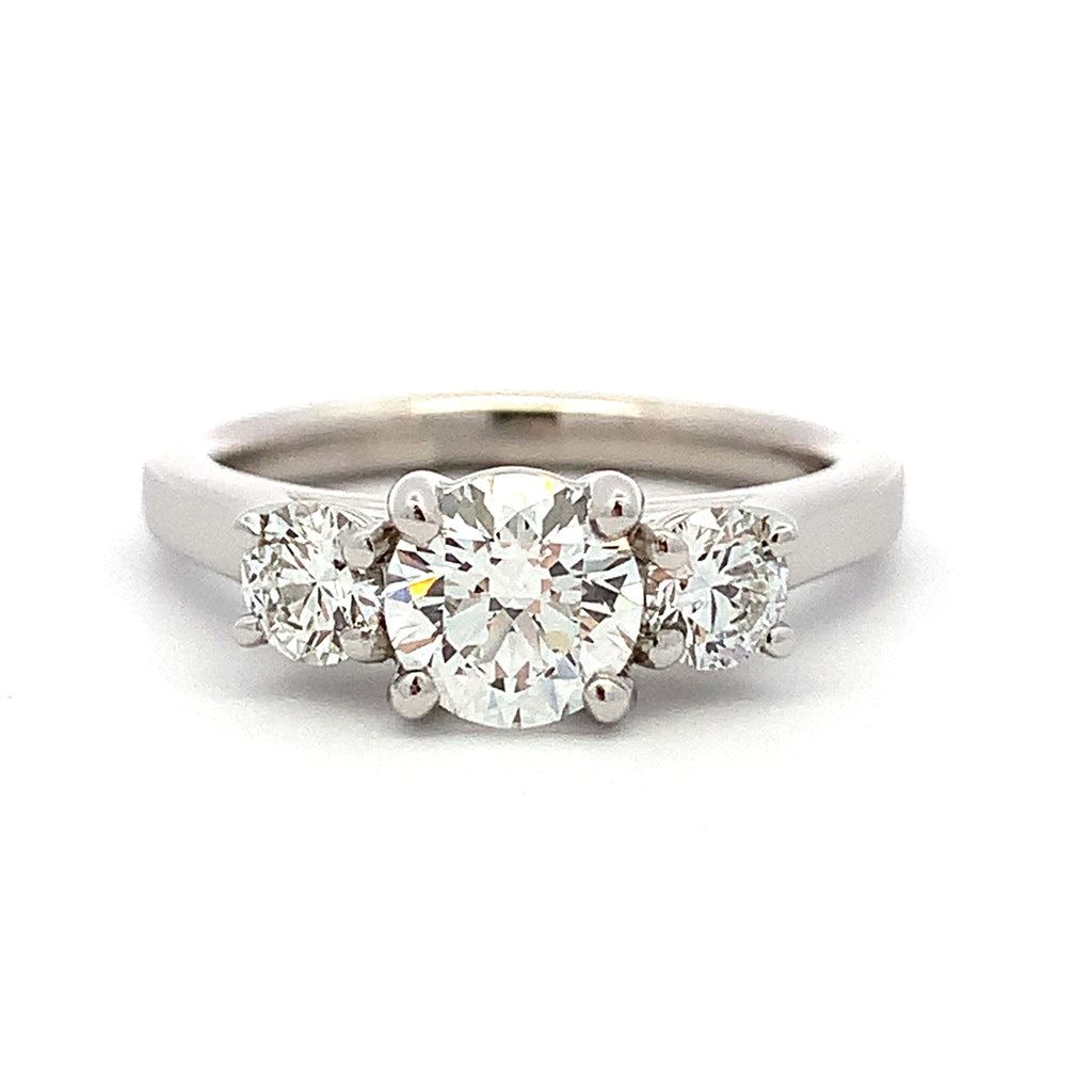 Diamond ring with three round-cut diamonds on a white background