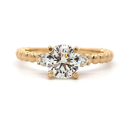 Gold ring with a large diamond on a white background