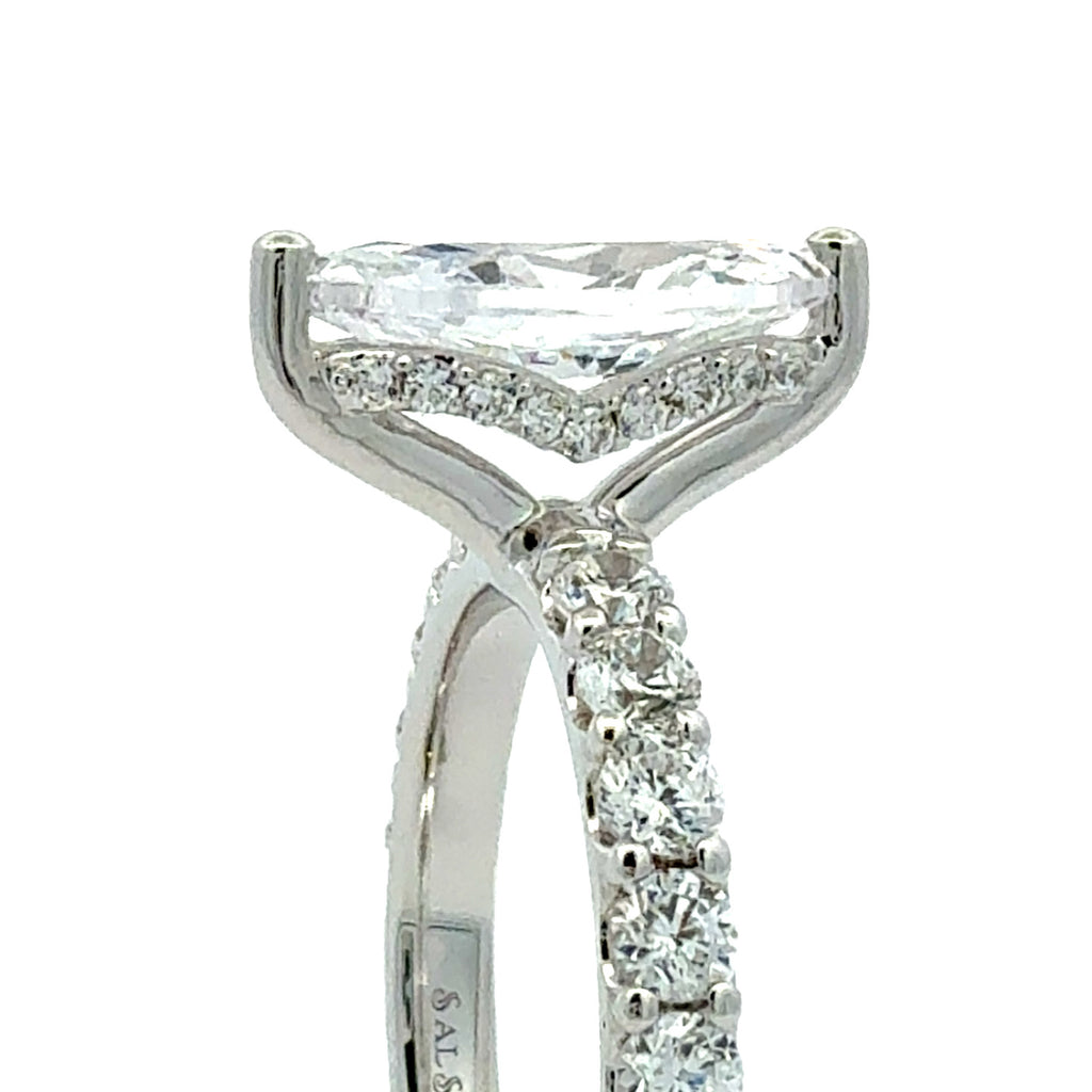 A close-up shot of a silver-toned diamond ring featuring a marquise-cut center stone and a pavé-set diamond band, shown against a plain white background.