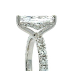 A close-up shot of a silver-toned diamond ring featuring a marquise-cut center stone and a pavé-set diamond band, shown against a plain white background.