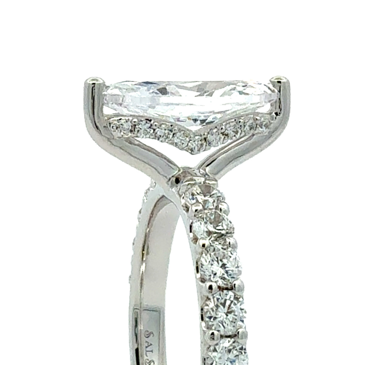 A close-up shot of a silver-toned diamond ring featuring a marquise-cut center stone and a pavé-set diamond band, shown against a plain white background.