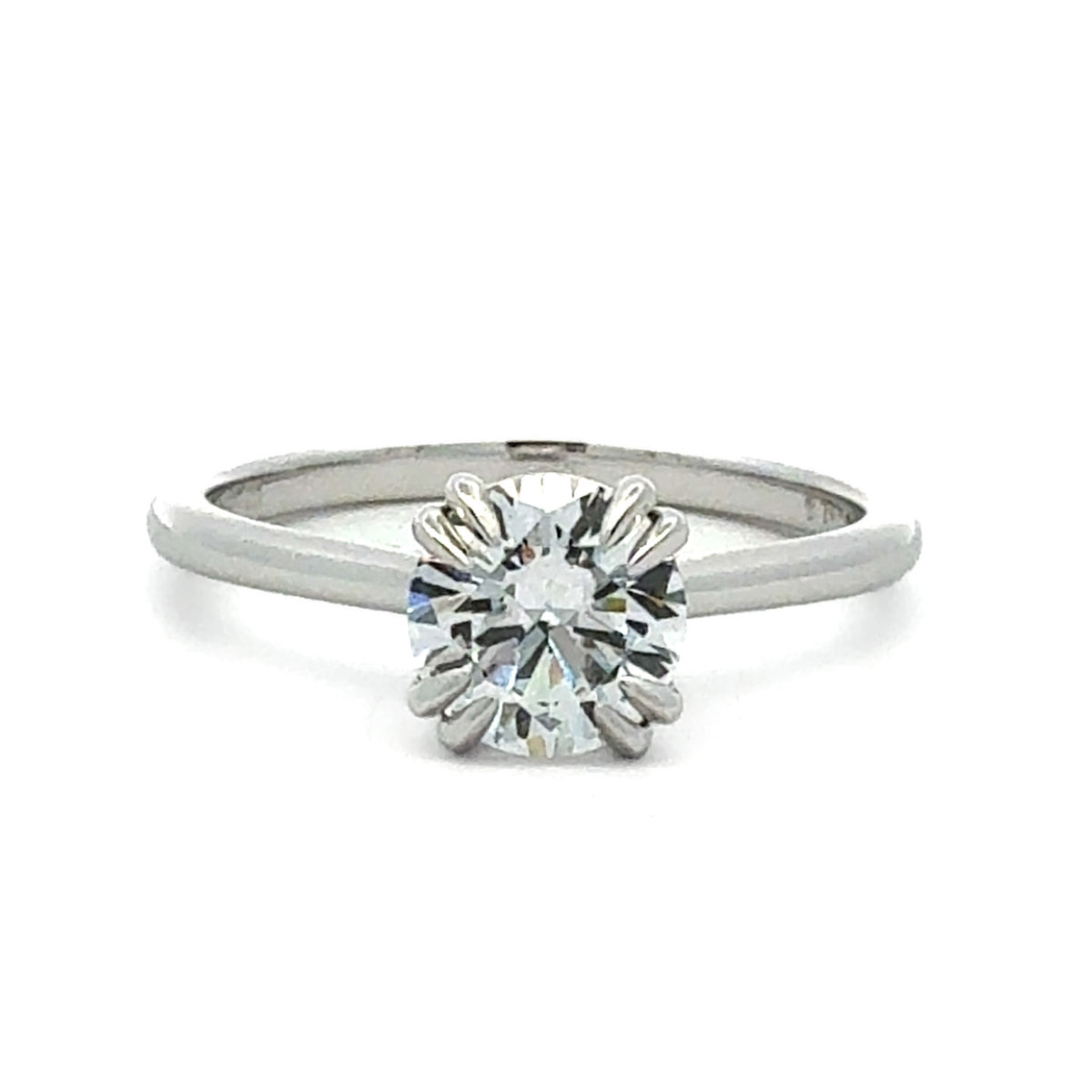 A silver-toned solitaire engagement ring featuring a round brilliant-cut diamond set in a prong setting, shown on a clean white background.