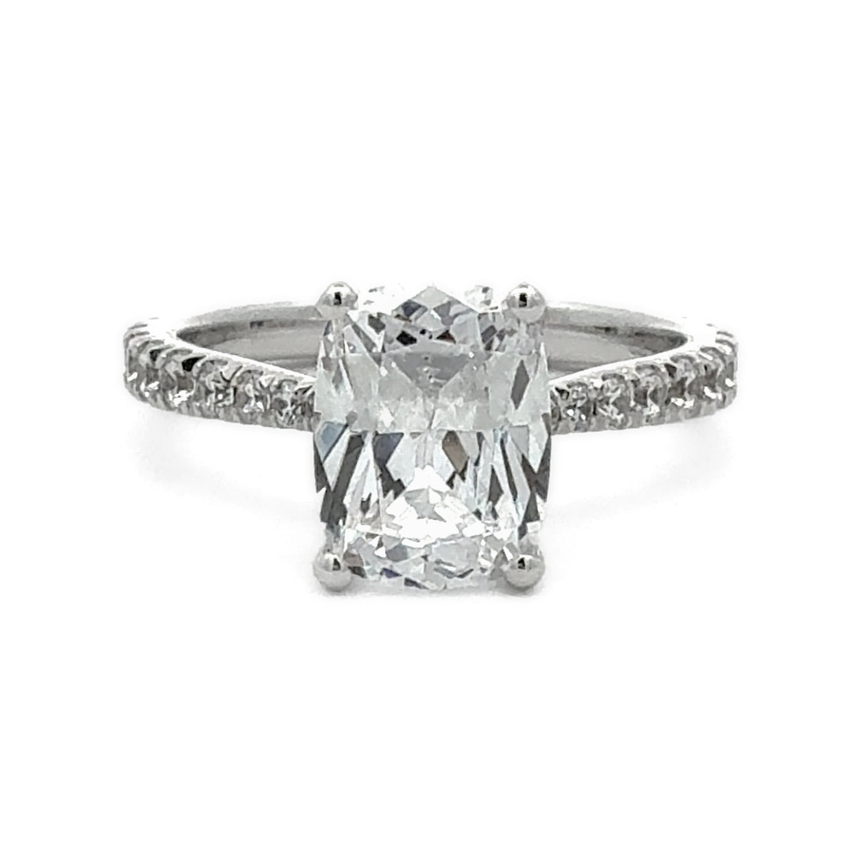 An emerald-cut diamond engagement ring with a silver-colored band featuring pavé-set accent diamonds, shown on a plain white background.