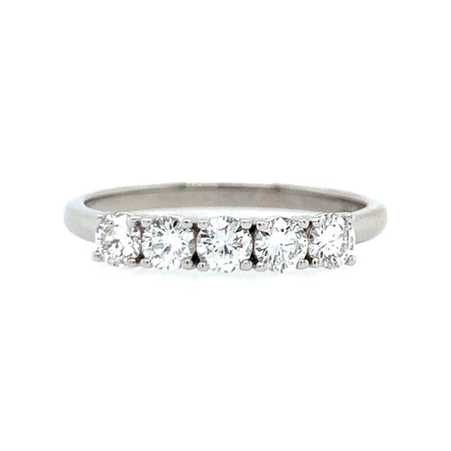 Diamond ring with four clear stones on a white background