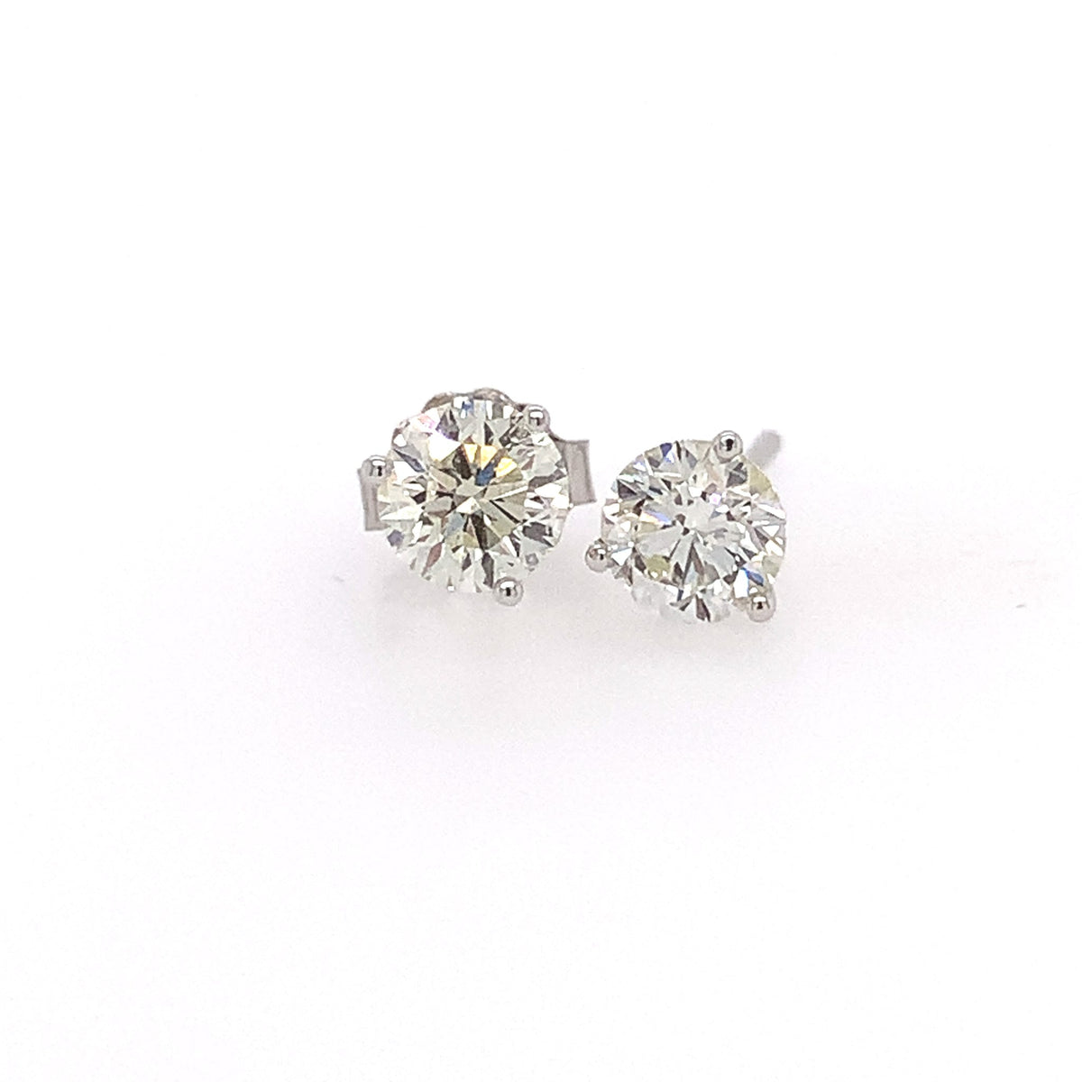 Pair of diamond stud earrings on a white background