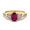 Gold ring with a pink gemstone and diamond accents on a white background