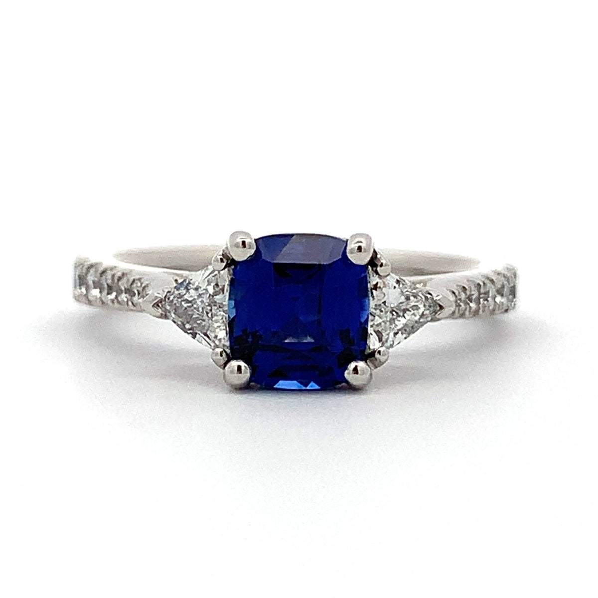 Ring with a blue gemstone and diamond accents on a white background