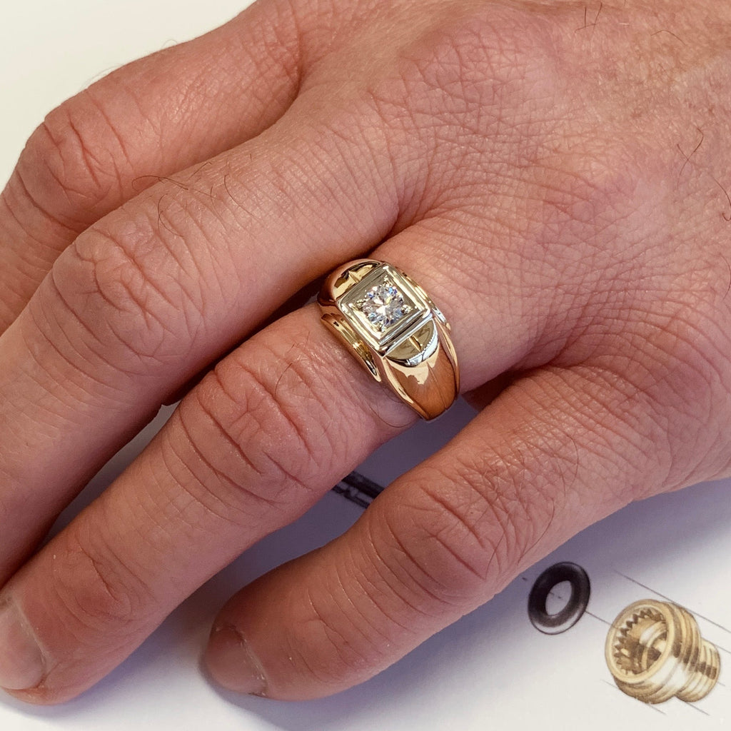 Gold ring with a diamond on a person's finger