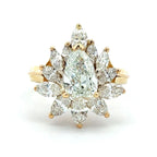 Gold ring with pear-shaped diamonds on a white background