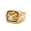 Men's yellow gold signet-style ring with a round diamond set in a carved, textured square face on a white background