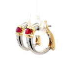 A pair of gold and silver hoop earrings with round red gemstones, shown on a white background.