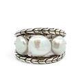 A silver ring featuring three large, lustrous white baroque pearls set in a braided, textured sterling silver band, photographed on a clean white background.