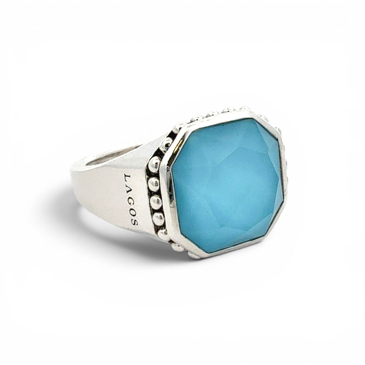 A silver signet ring featuring a faceted light blue octagonal stone, with decorative silver dots along the bezel and the brand name 'LAGOS' engraved on the band, set against a plain white background.
