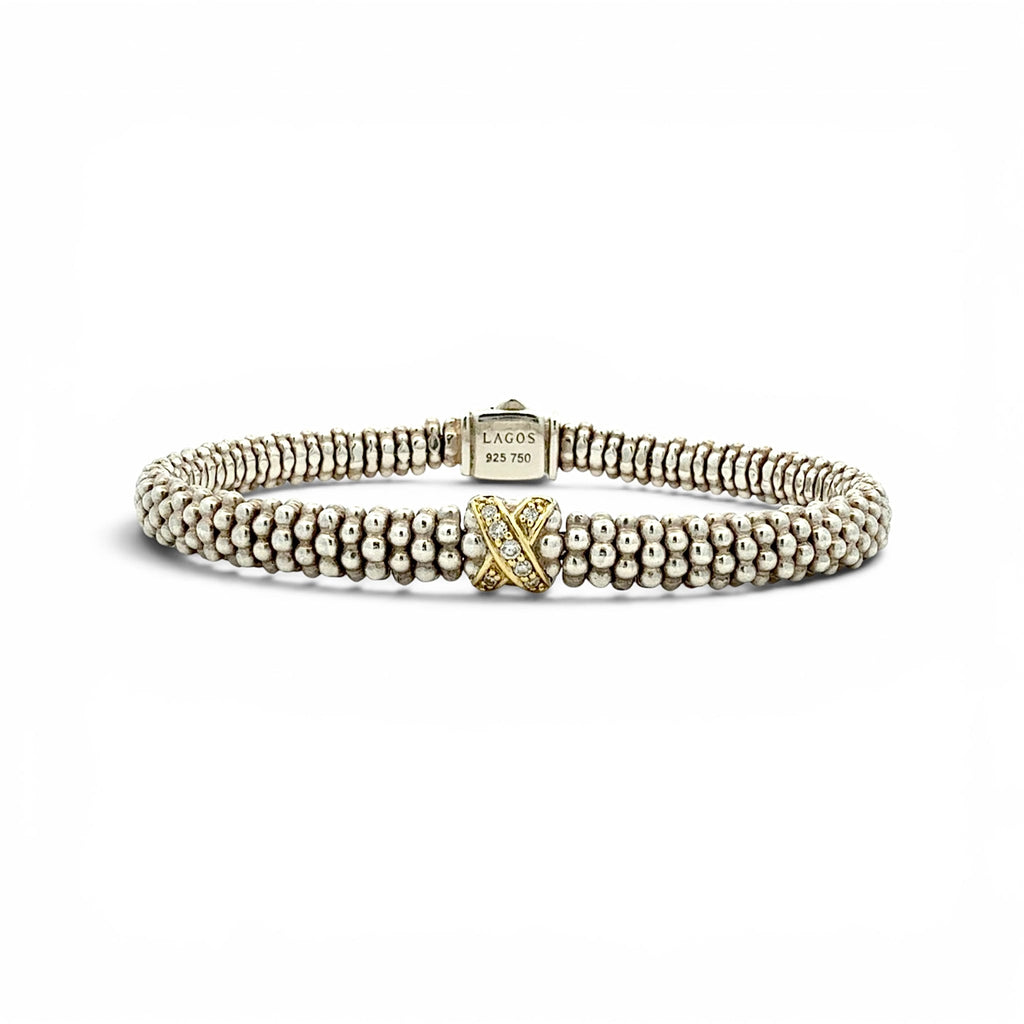 A Lacoste beaded bracelet in silver-tone metal with a central yellow gold 'L' accent, displayed on a clean white background.