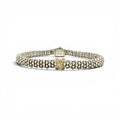 A Lacoste beaded bracelet in silver-tone metal with a central yellow gold 'L' accent, displayed on a clean white background.