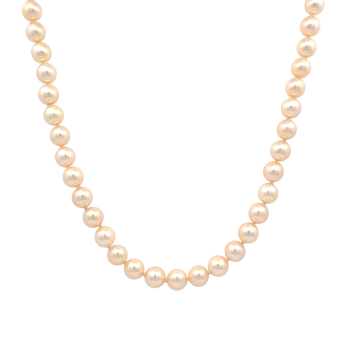 A strand of round, cream-colored freshwater pearls arranged in a curved necklace shape against a solid white background.