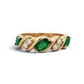 A yellow gold ring featuring marquise-cut emeralds and small round diamonds, set in a twisted wrap design on a white background.