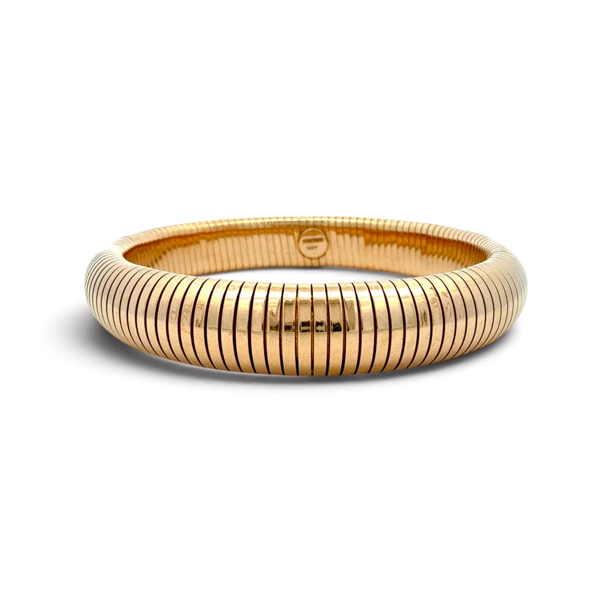 A polished yellow gold bangle bracelet with a distinctive ribbed, snake-like segmented exterior, shown on a clean white background.