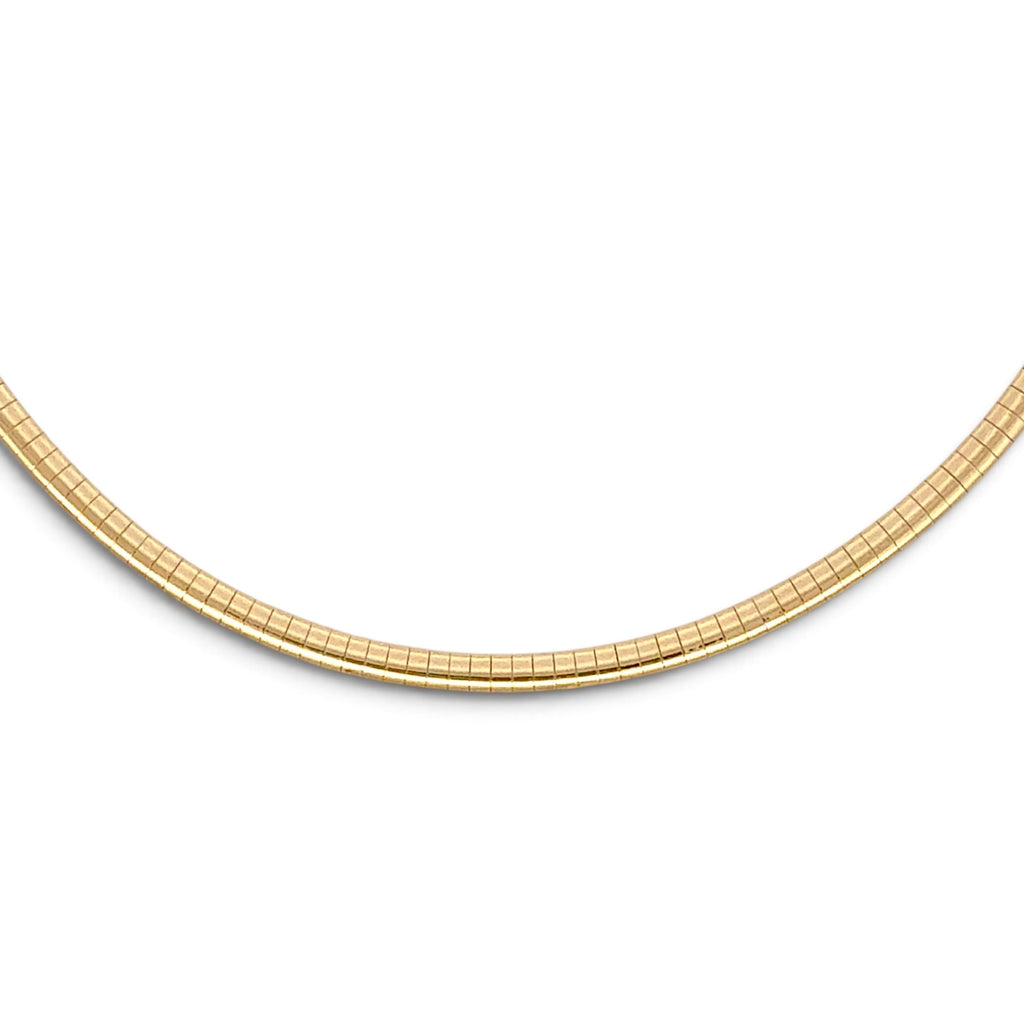A close-up of a gold tennis-style chain necklace against a plain white background.