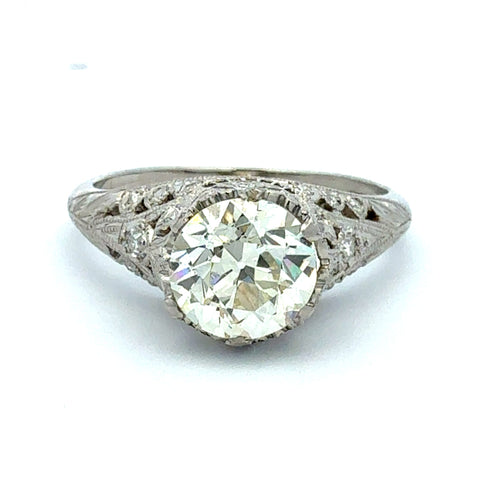 Diamond ring with intricate design on a white background
