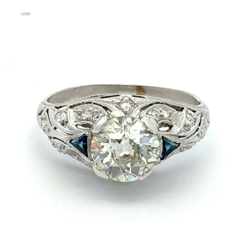 Diamond ring with intricate design on a white background
