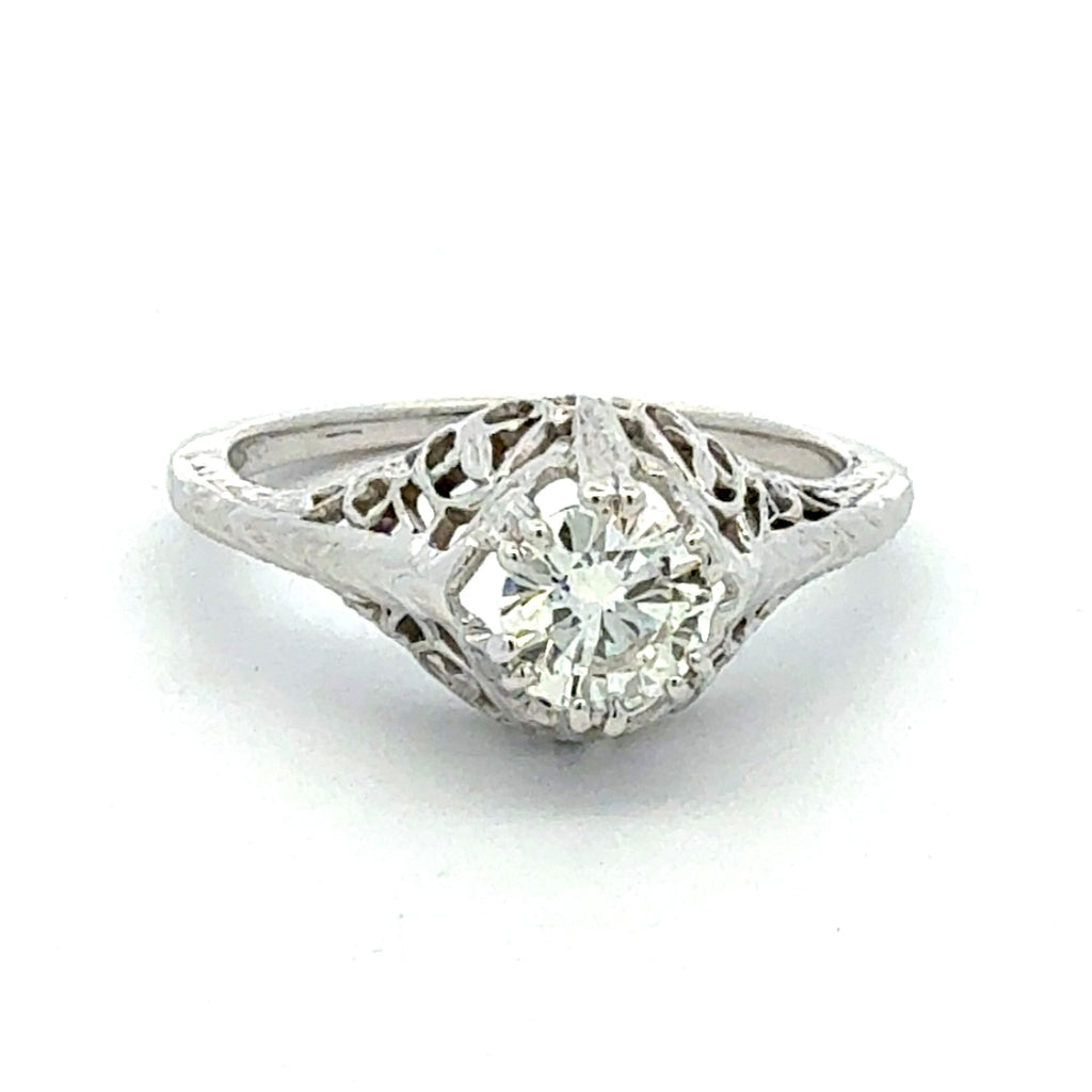 Diamond ring with intricate filigree design on a white background