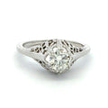 Diamond ring with intricate filigree design on a white background