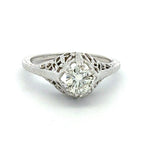 Diamond ring with intricate filigree design on a white background