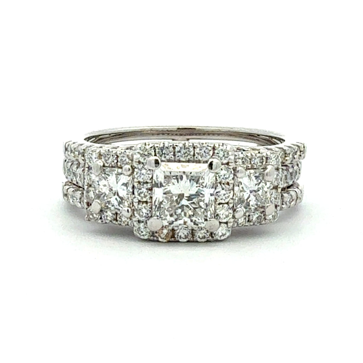 Diamond ring with multiple stones on a white background
