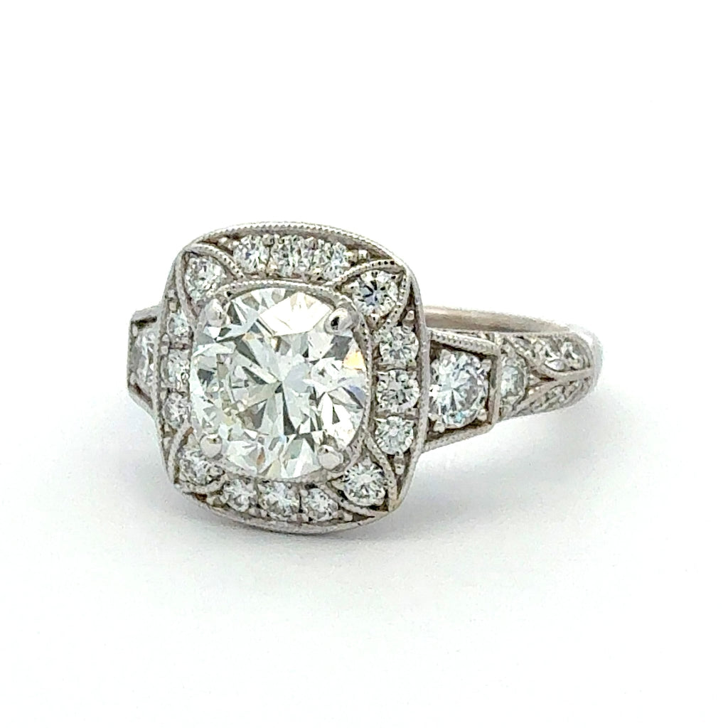 Diamond ring with a large central gemstone and smaller diamonds in the setting on a white background