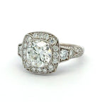 Diamond ring with a large central gemstone and smaller diamonds in the setting on a white background