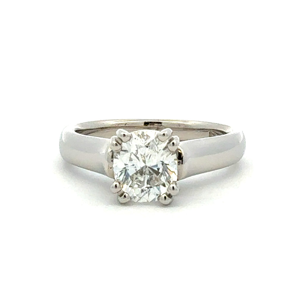 A classic solitaire engagement ring featuring a round brilliant-cut diamond set in a polished silver-colored metal band, shown against a plain white background.