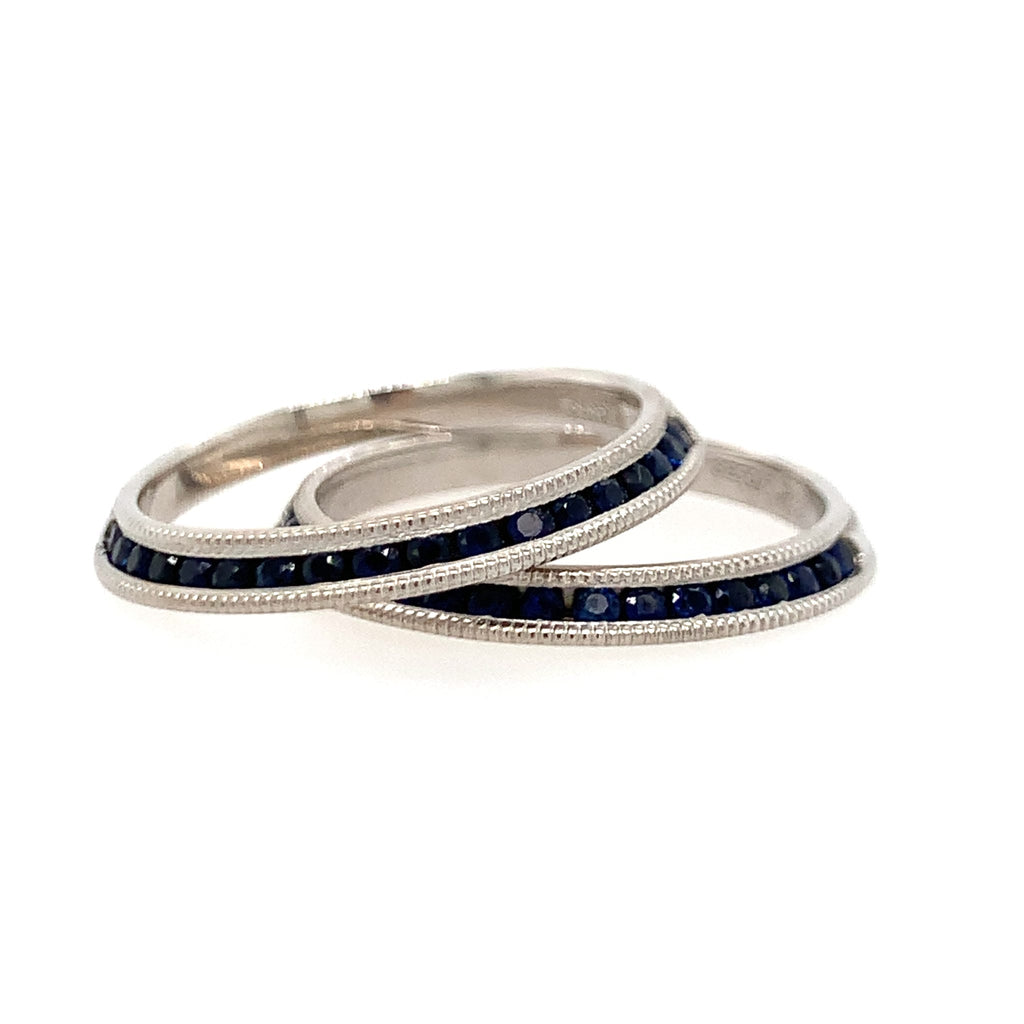 Three silver rings with blue gemstones on a white background
