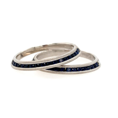 Three silver rings with blue gemstones on a white background