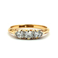 Gold ring with three diamonds on a white background