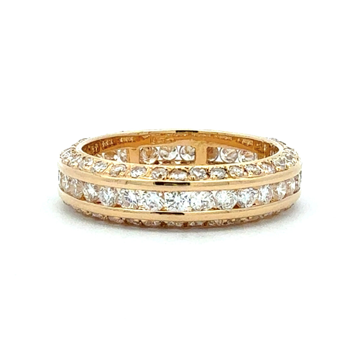 Gold ring with diamond accents on a white background