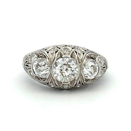 Diamond ring with intricate metalwork on a white background