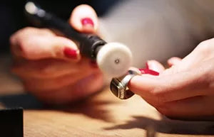 Goldsmith repairing a piece of jewelry at Moses Jewelers
