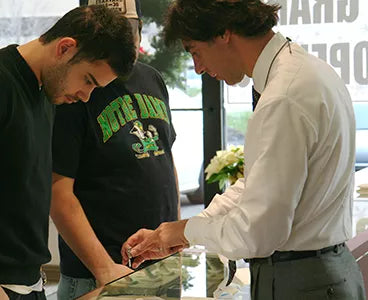 Tim Moses with customers at a diamond sale event